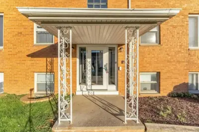 awning over a front door of a brick building at Heights Dream Libby Unit 6 in Maple Heights