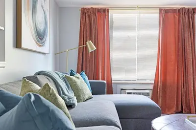 a living room with a couch and a window at Heights Dream Libby Unit 6 in Maple Heights