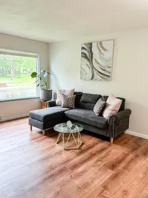 a living room with a couch and a table at Akron Abode - 2pm Check In & Out in Akron