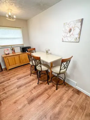 a dining room with a table and four chairs at Akron Abode - 2pm Check In & Out in Akron