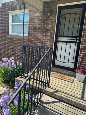 a house with a black door and some flowers at Akron Abode - 2pm Check In & Out in Akron