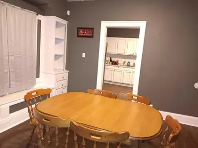a dining room with a wooden table and chairs at Experience a home near Cleveland Clinic & parks in Cleveland