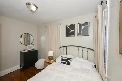 a bedroom with a bed and a table with a mirror at Spacious 3-Bed In Vibrant Tremont in Cleveland