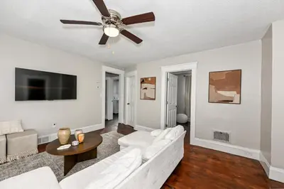 a living room with a white couch and a ceiling fan at Spacious 3-Bed In Vibrant Tremont in Cleveland