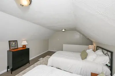 a bedroom with two beds in a attic at Spacious 3-Bed In Vibrant Tremont in Cleveland