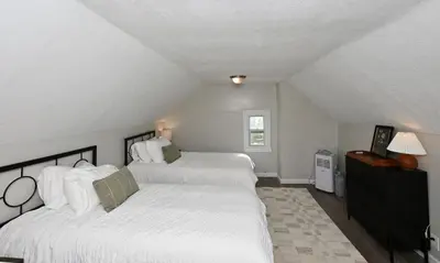 a bedroom with two beds with white sheets at Spacious 3-Bed In Vibrant Tremont in Cleveland