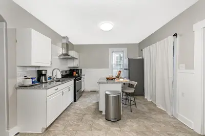 a kitchen with white cabinets and a counter top at 3 Bed Spacious 1st Floor Apt at Tremont in Cleveland