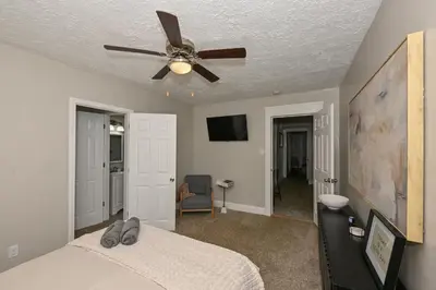 a bedroom with a ceiling fan and a bed at 3 Bed Spacious 1st Floor Apt at Tremont in Cleveland