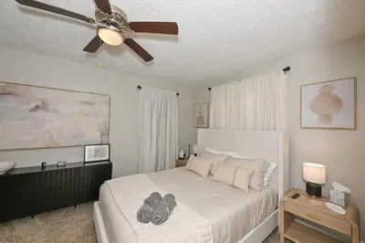 a bedroom with a bed with a ceiling fan at 3 Bed Spacious 1st Floor Apt at Tremont in Cleveland
