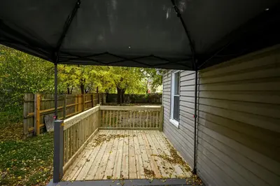 a porch of a house with a black canopy at 3 Bed Spacious 1st Floor Apt at Tremont in Cleveland
