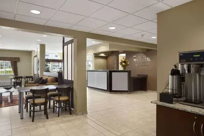a waiting area in a dental office with a table and chairs at Microtel Inn and Suites Carrollton in Carrollton