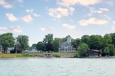 a large house on the shore of a body of water at New! Kelleys Island Condo in Kelleys Island