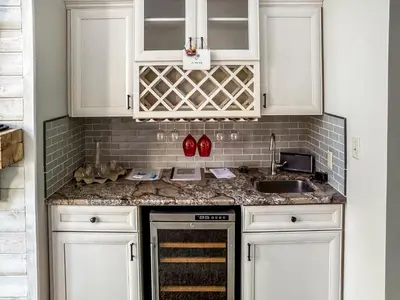 a kitchen with white cabinets and a sink at New! Kelleys Island Condo in Kelleys Island