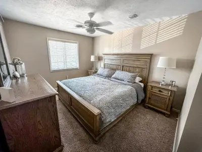 a bedroom with a bed and a ceiling fan at New! Kelleys Island Condo in Kelleys Island