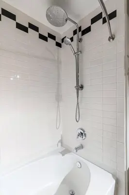 a bathroom with a shower and a white tub at CBD OTR Pool Gym Free Parking Steps to Stadiums in Cincinnati