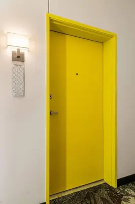a yellow door in a room with a light at CBD OTR Pool Gym Free Parking Steps to Stadiums in Cincinnati