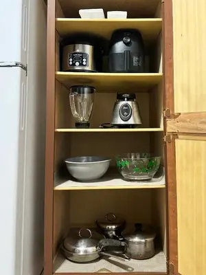 a cupboard filled with pots and pans and a blender at Beautiful 2 BDRM Ocean Inspired Oasis in Youngstown