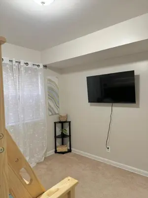 a living room with a flat screen tv on a wall at Beautiful 2 BDRM Ocean Inspired Oasis in Youngstown