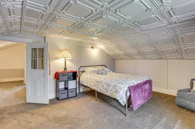 a bedroom with a bed and a coffered ceiling at Large Yard and Fire Pit Pet-Friendly Ravenna Home! in Streetsboro
