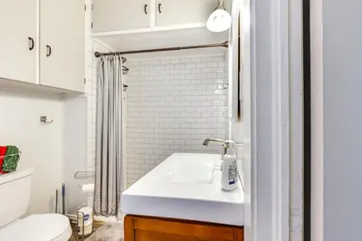 a bathroom with a white sink and a toilet at Large Yard and Fire Pit Pet-Friendly Ravenna Home! in Streetsboro