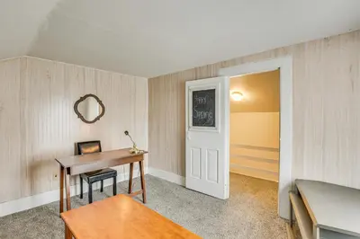 a room with a desk and a table with a mirror at Large Yard and Fire Pit Pet-Friendly Ravenna Home! in Streetsboro