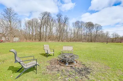 two chairs and a fire pit in a field at Large Yard and Fire Pit Pet-Friendly Ravenna Home! in Streetsboro