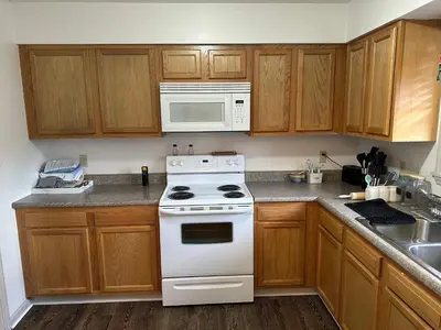 a kitchen with a white stove and a microwave at Cozy apartment embedded in Kentucky mountains in Hagerhill