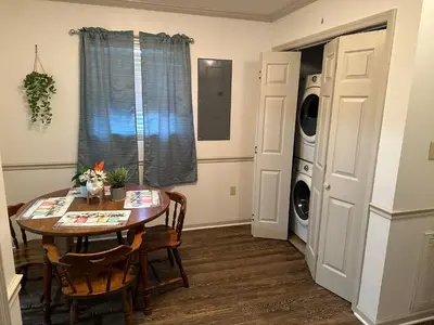 a dining room with a table and a washing machine at Cozy apartment embedded in Kentucky mountains in Hagerhill