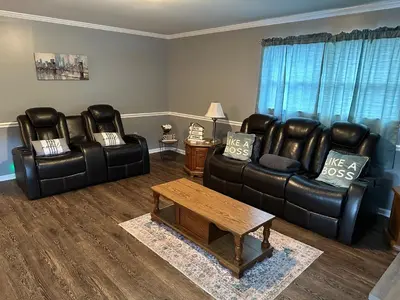 a living room with two leather chairs and a coffee table at Cozy apartment embedded in Kentucky mountains in Hagerhill