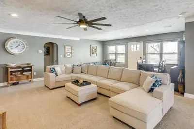 a living room with a couch and a ceiling fan at 5 Mi to Lake Port Clinton Home with Gazebo and Grill! in Port Clinton