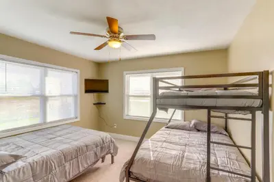 a bedroom with two bunk beds and a ceiling fan at 5 Mi to Lake Port Clinton Home with Gazebo and Grill! in Port Clinton