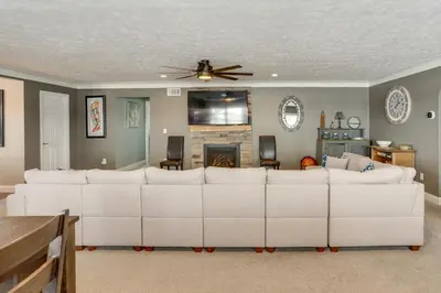 a living room with a white couch and a fireplace at 5 Mi to Lake Port Clinton Home with Gazebo and Grill! in Port Clinton