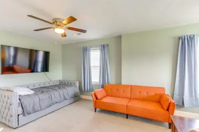 a bedroom with a bed and a couch and a ceiling fan at 5 Mi to Lake Port Clinton Home with Gazebo and Grill! in Port Clinton