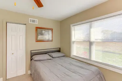 a bedroom with a bed and a large window at 5 Mi to Lake Port Clinton Home with Gazebo and Grill! in Port Clinton