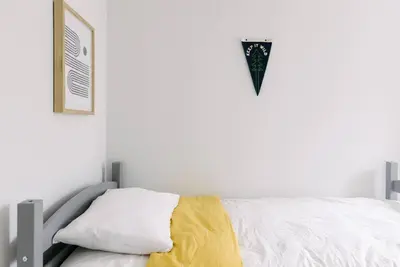 a bedroom with a bed with a yellow blanket on it at Cuyahoga Valley NP, Dog Friendly, Boston Mills Ski in Brecksville
