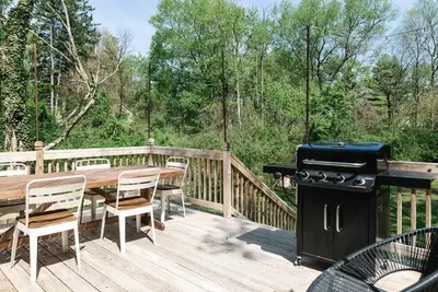 a wooden deck with a table and a grill at Cuyahoga Valley NP, Dog Friendly, Boston Mills Ski in Brecksville