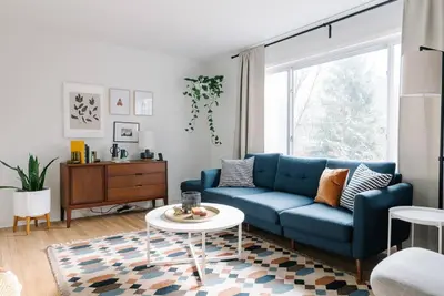 a living room with a blue couch and a table at Cuyahoga Valley NP, Dog Friendly, Boston Mills Ski in Brecksville