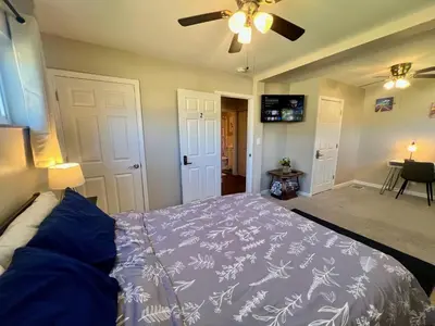 a bedroom with a bed and a ceiling fan at Sunny Stay Bright and Cozy Suite 2 in Cincinnati