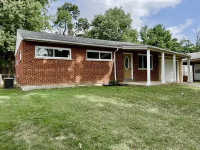 a home with a brick house with a yard at Sunny Stay Bright and Cozy Suite 2 in Cincinnati