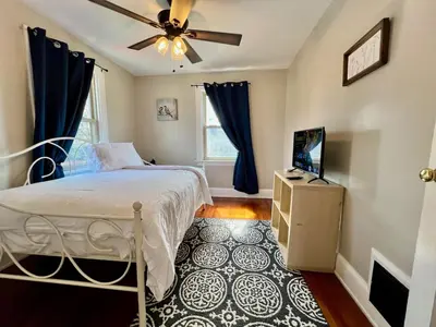 a bedroom with a bed and a ceiling fan at Cozy Bungalow Quiet Neighborhood Queen Bed Suite 3 10 Min to Downtown in Cincinnati