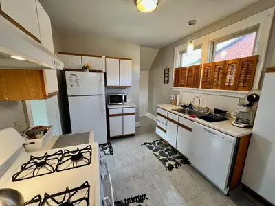 a kitchen with white appliances and a white refrigerator at Cozy Bungalow Quiet Neighborhood Queen Bed Suite 3 10 Min to Downtown in Cincinnati