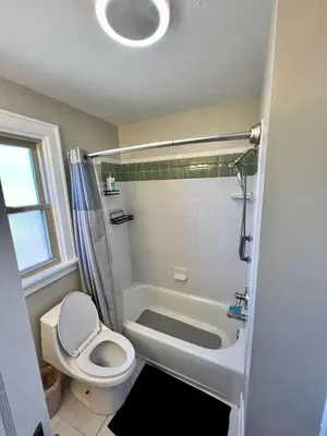 a bathroom with a toilet and a shower and a sink at Comfy Cozy Bungalow Suite 2 10 min from Downtown in Cincinnati