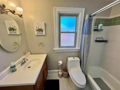 a bathroom with a sink and a toilet and a mirror at Comfy Cozy Bungalow Suite 2 10 min from Downtown in Cincinnati