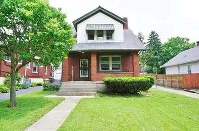a red brick house with a tree in a yard at Comfy Cozy Bungalow Suite 2 10 min from Downtown in Cincinnati