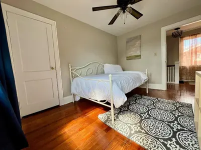 a bedroom with a bed and a rug at Comfy Cozy Bungalow Suite 2 10 min from Downtown in Cincinnati