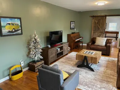 a living room with a christmas tree and a television at River House on the Little Miami in Milford