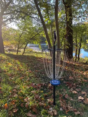 a frisbee golf basket in the grass in a park at River House on the Little Miami in Milford