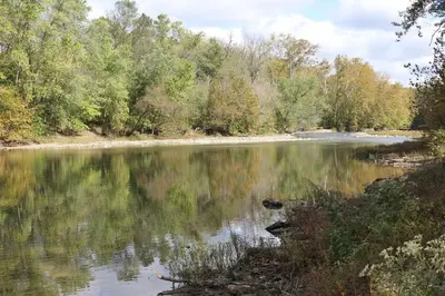 a view of a lake with trees in the background at River House on the Little Miami in Milford