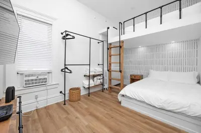 a bedroom with a bunk bed and a desk at Downtown Adams in Sandusky