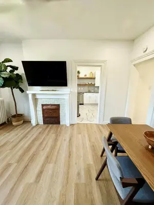 a living room with a table and a fireplace at Downtown Adams in Sandusky
